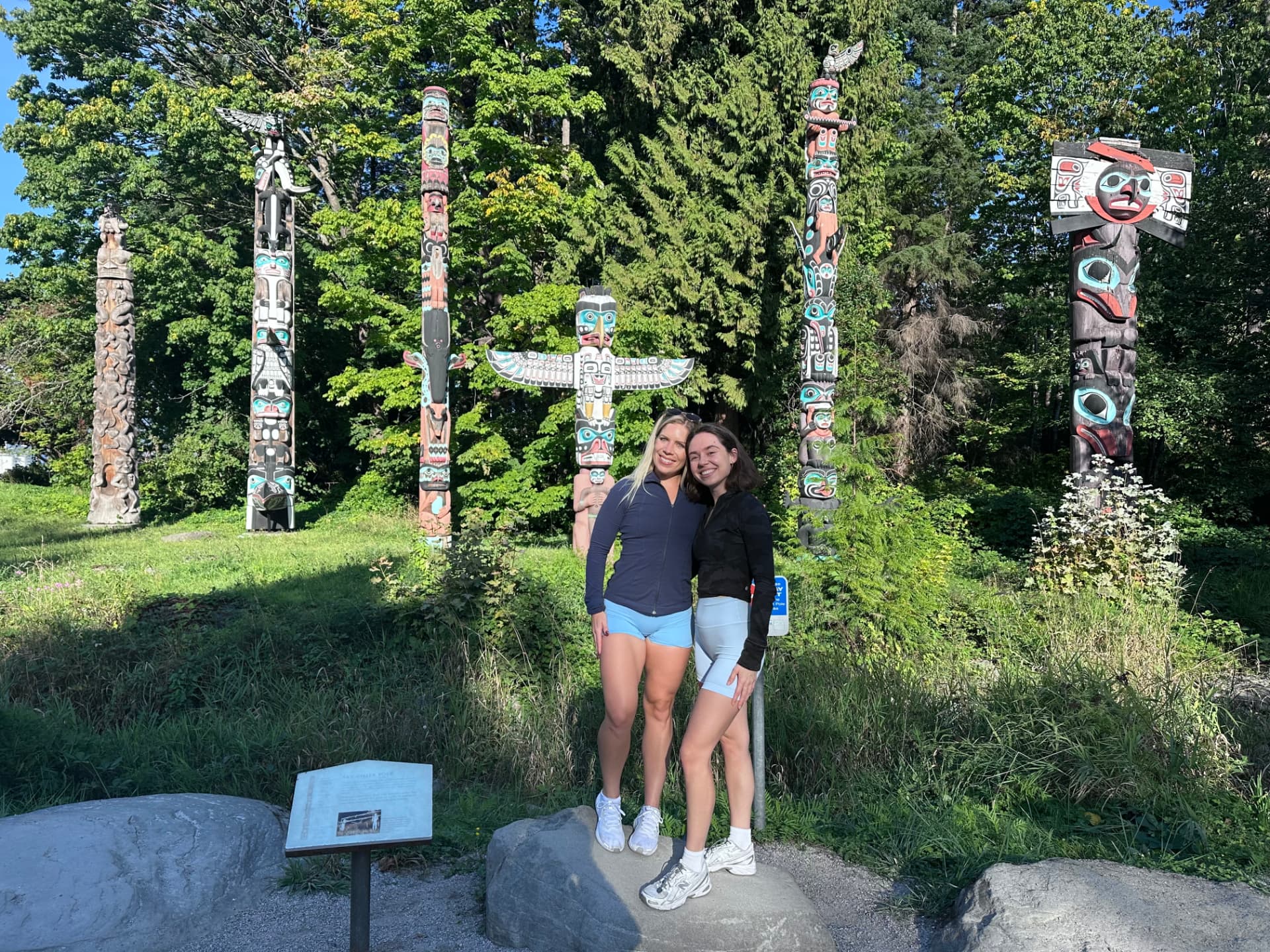 Friends by the totem poles on a sunny day
