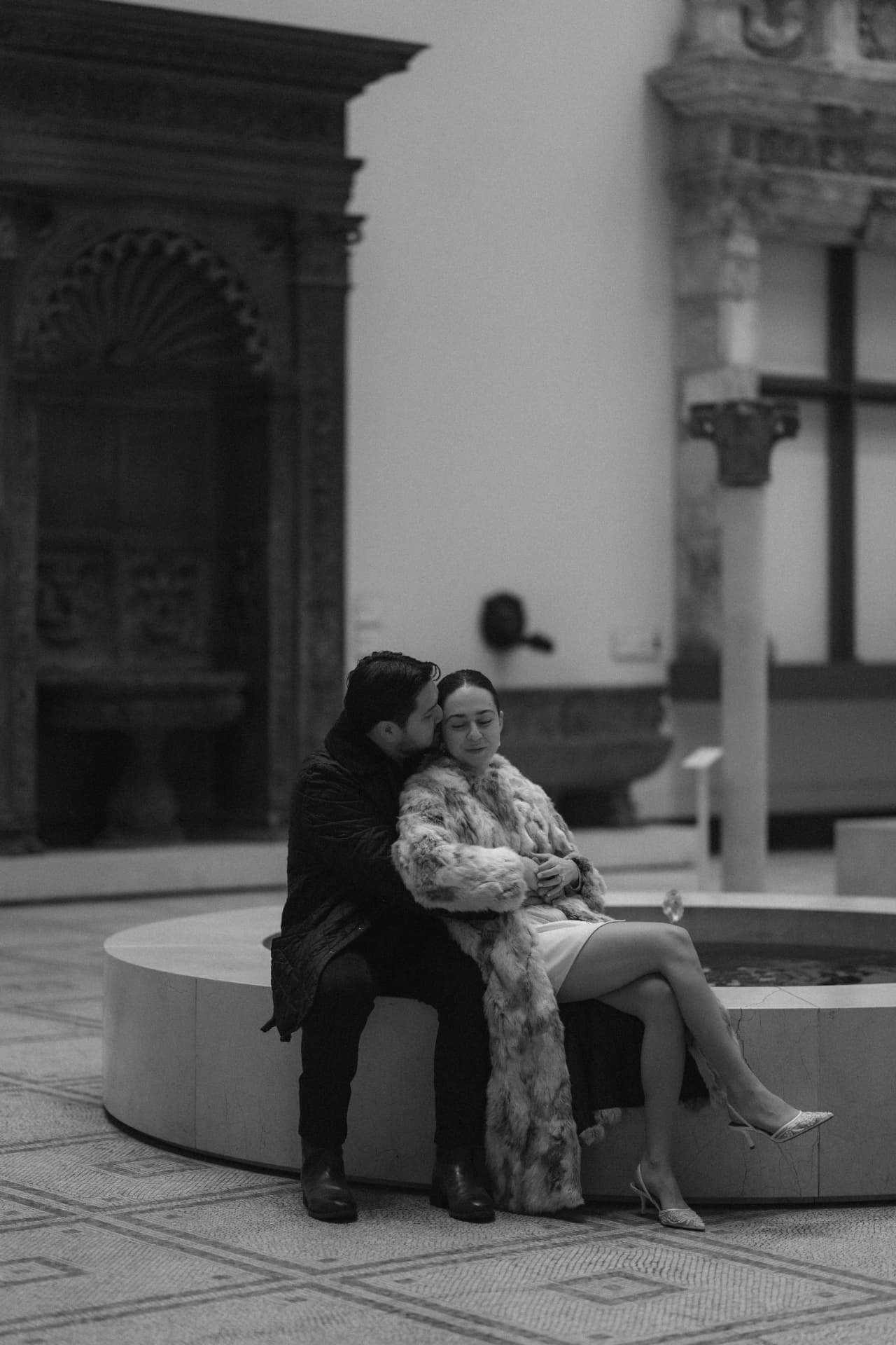 Engagement portrait by a fountain