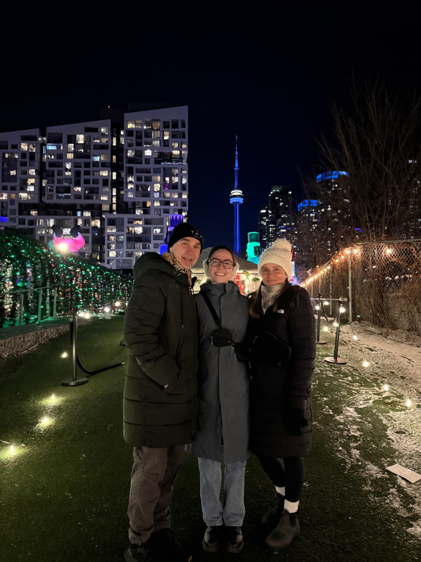 Family enjoying a winter evening beneath the Toronto skyline